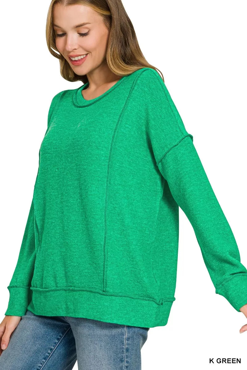 Side angle of bright green drop shoulder sweater with round neck and long sleeves