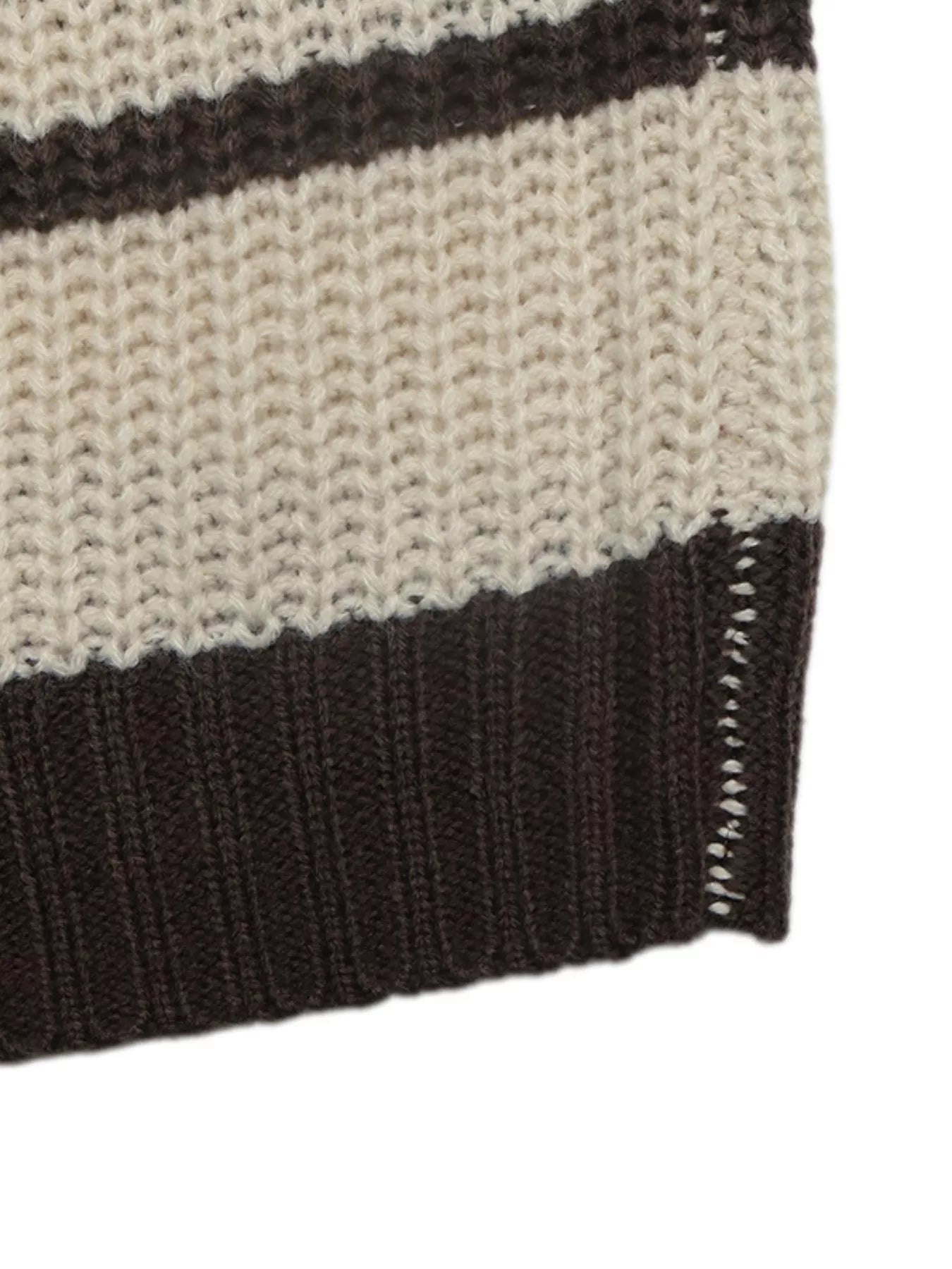 Close up of the brown ribbed hem on a cream and brown striped knit sweater.