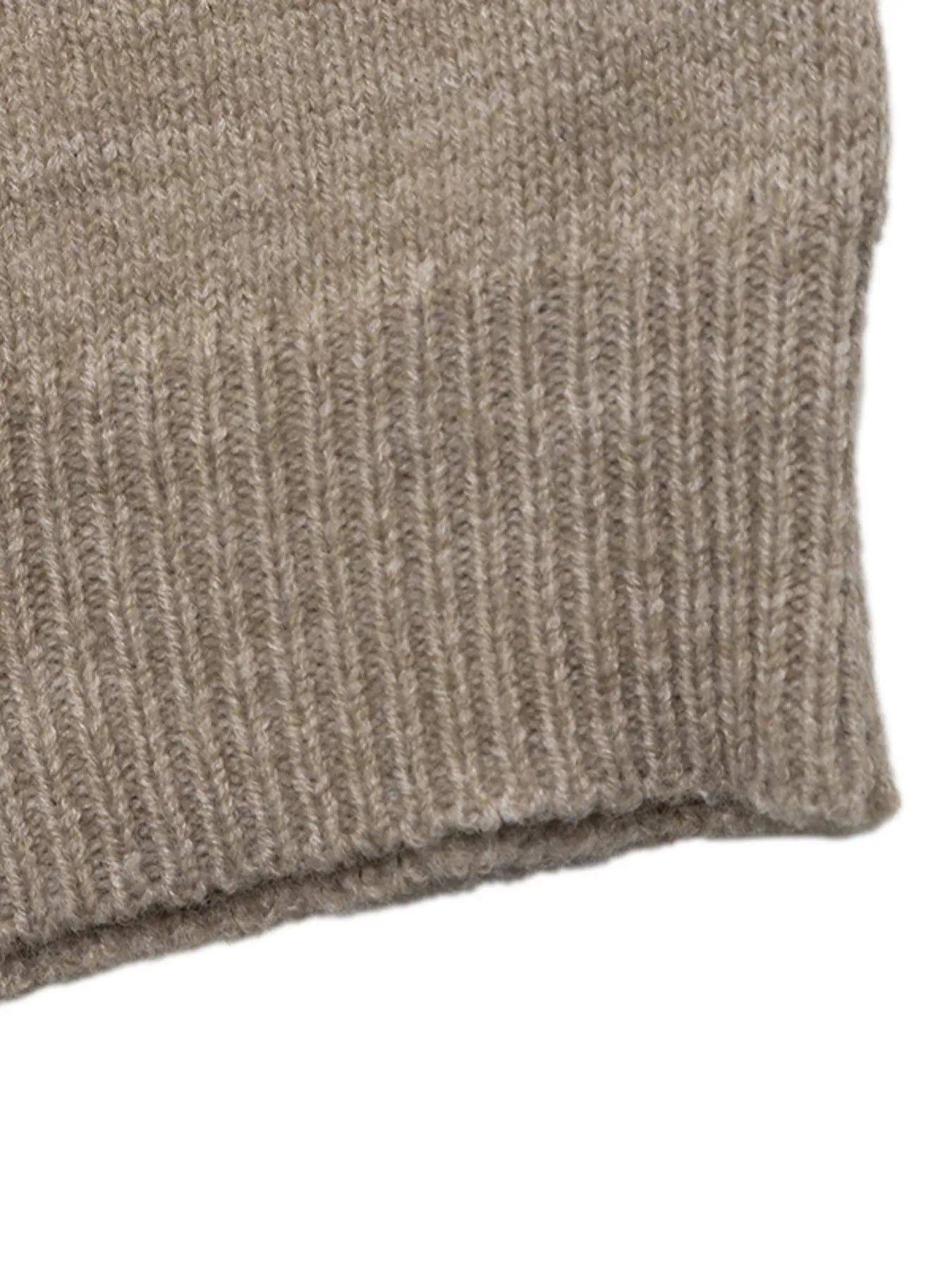 Close up of ribbed hem on khaki dropped shoulder sweater showing knit texture