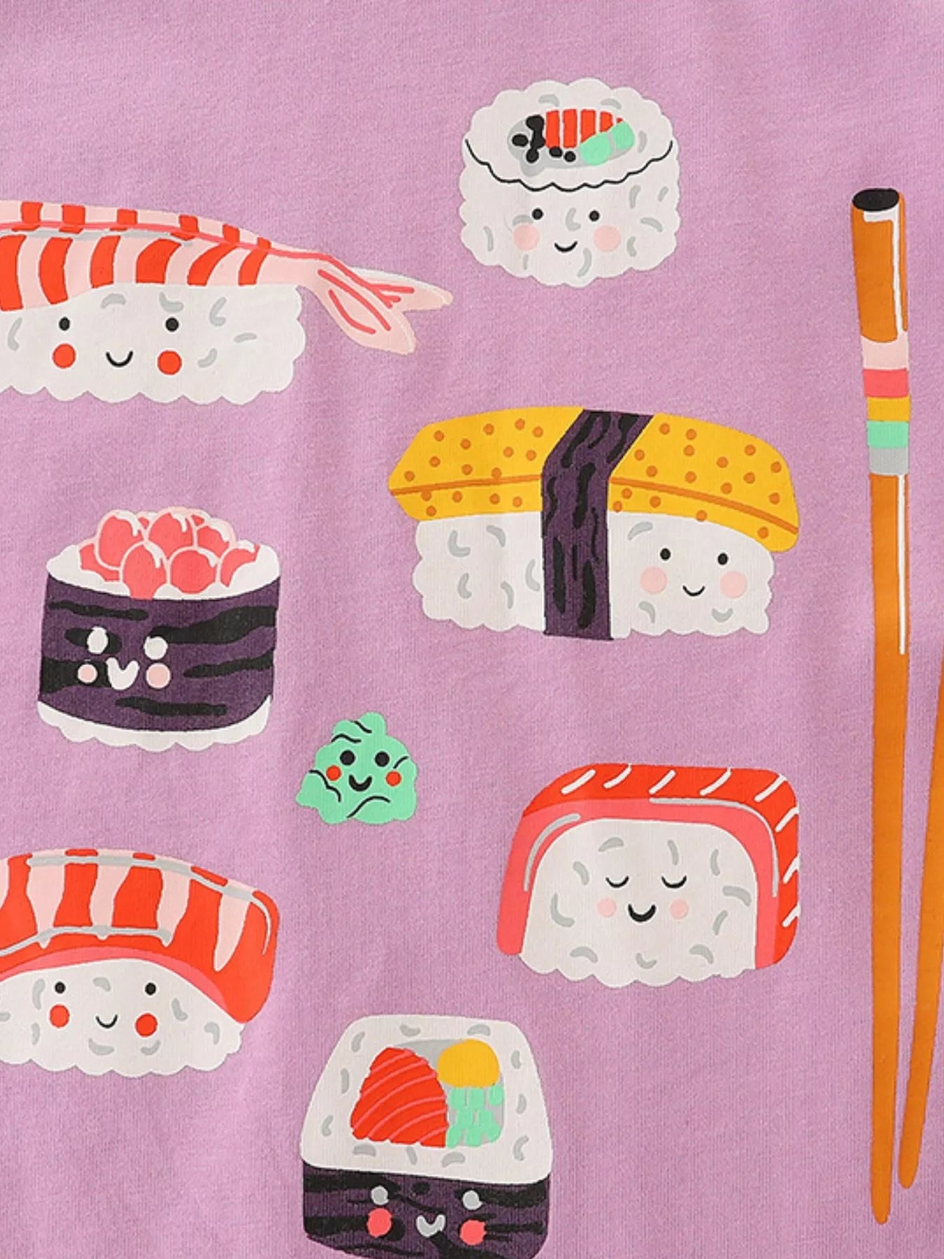 Close-up of the smiling sushi pieces and orange chopsticks on dusty pink fabric