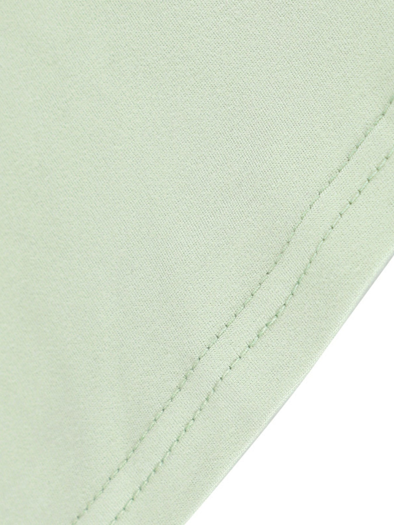 Close view of light green seam stitching on a floral bodycon mermaid maxi dress