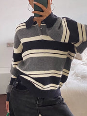 On-model front view of the navy, gray, and cream striped sweater with ribbed cuffs