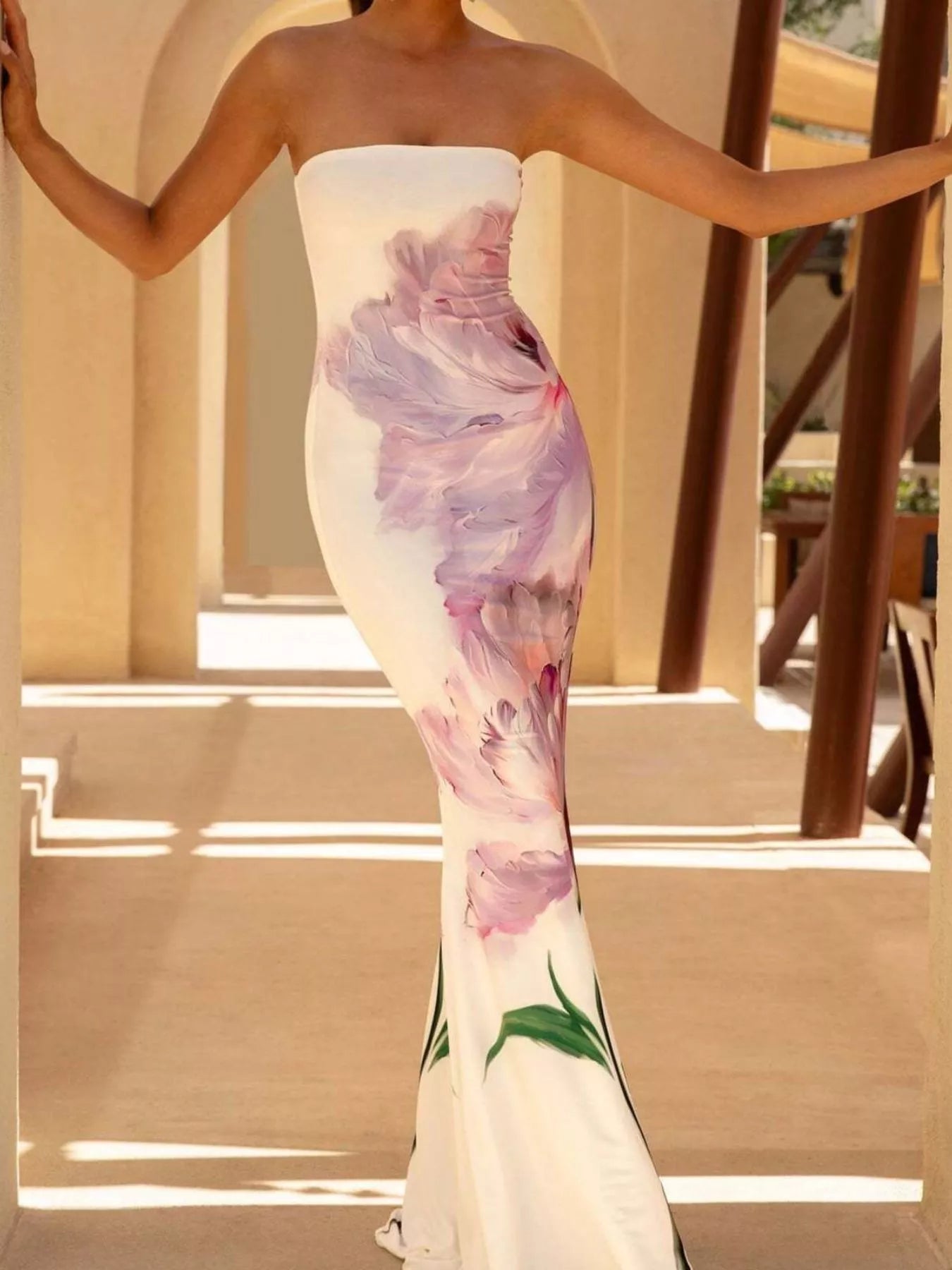 Model wearing strapless white and purple floral tube maxi dress, front view with arms outstretched