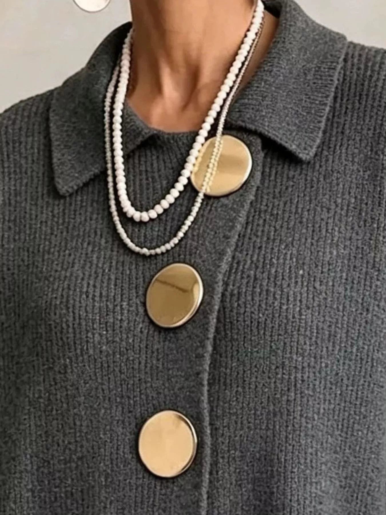 Close up of the dark gray cardigan collar and large gold buttons