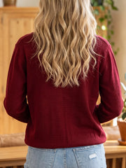 Back view of the plain burgundy long sleeve knit cardigan on model
