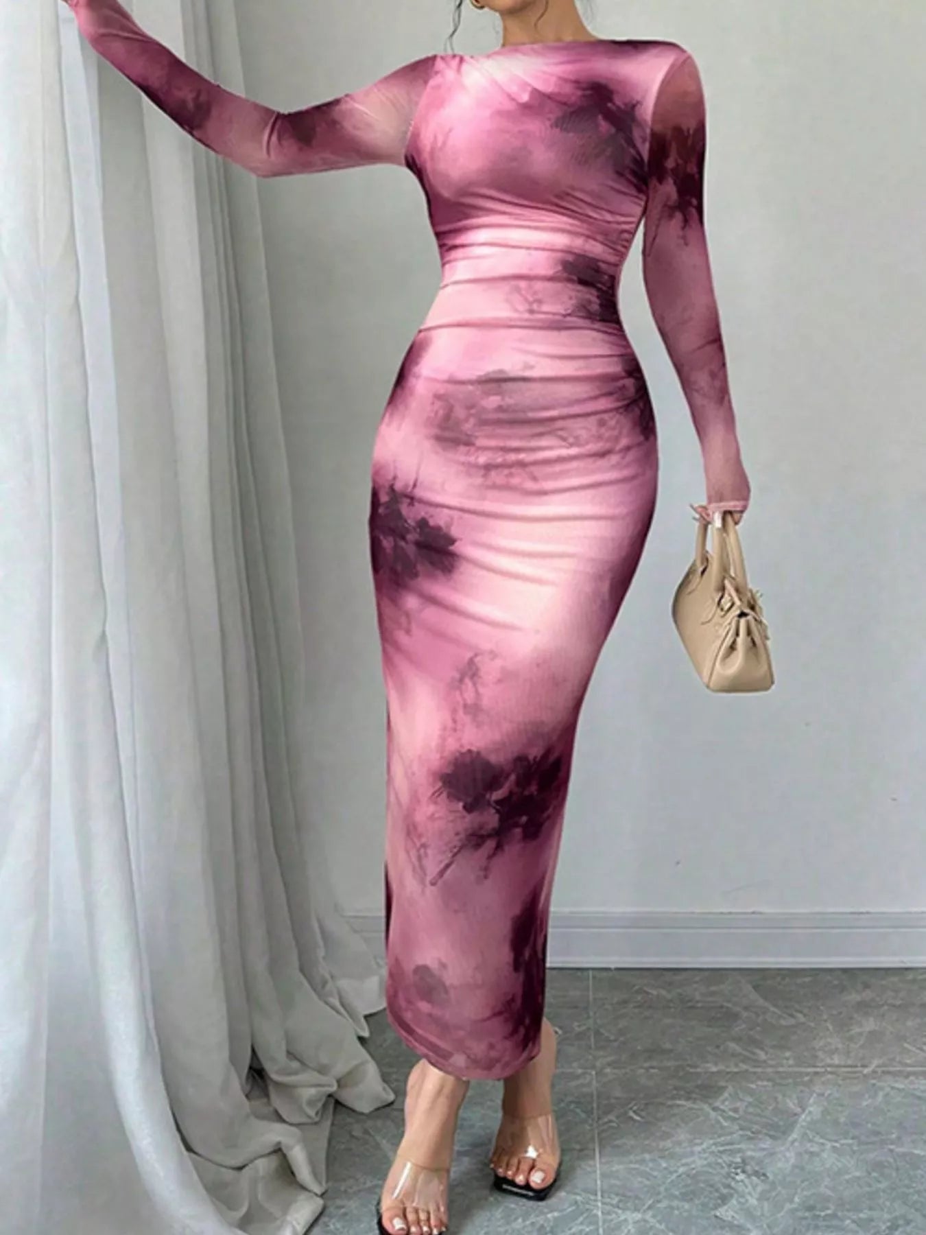 Pink tie dye long sleeve bodycon maxi dress worn front facing with one arm raised