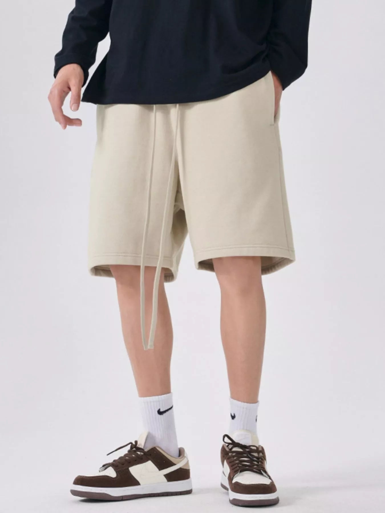 Men's beige casual shorts with a drawstring waist.