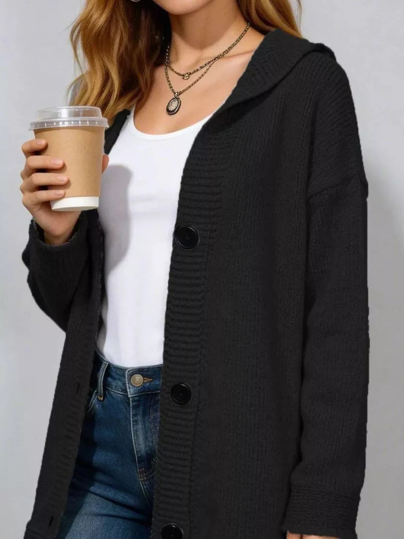 Close front view of the black hooded cardigan with ribbed button placket