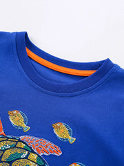 Angled close-up of royal blue children's t-shirt collar with orange inner trim