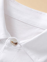 Close up of the polo collar and top button on a white children's short sleeve shirt