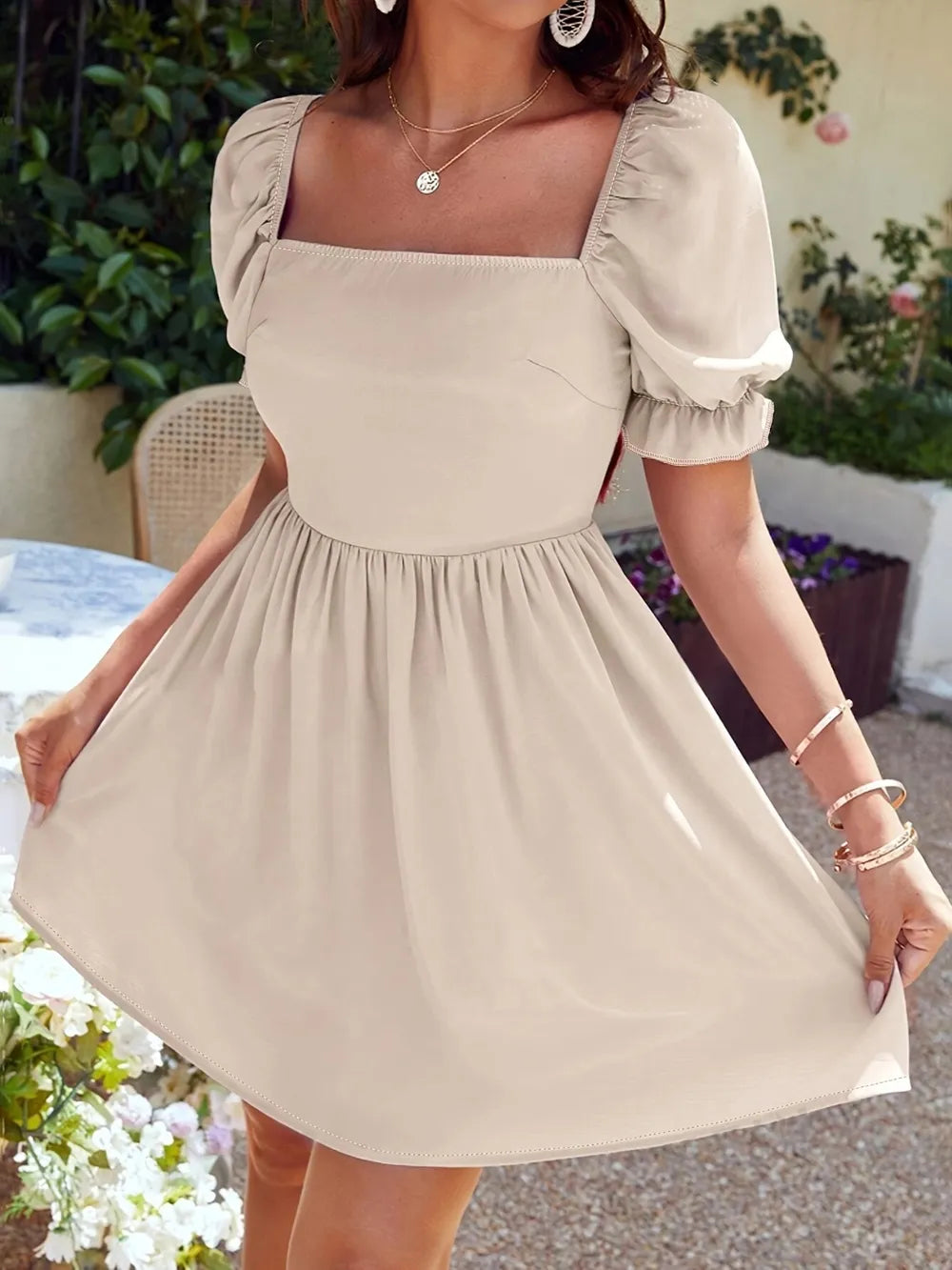 Women's mini dress with a square neckline and flounce sleeves.