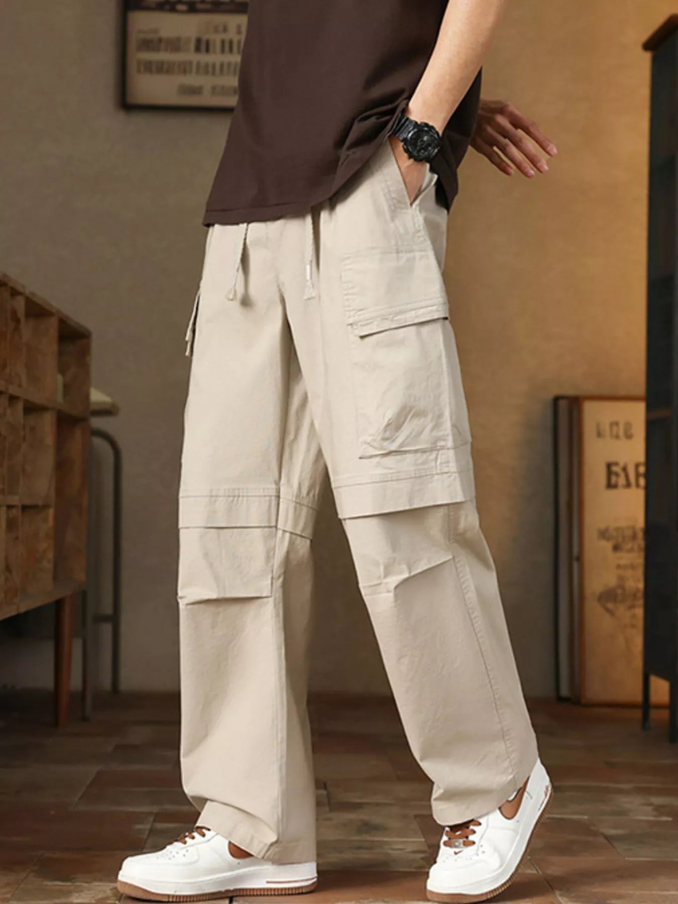 Men's relaxed fit cargo pants with a drawstring waist and pockets.