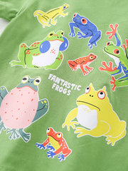 Close-up of colorful cartoon frogs print on lime children's t-shirt fabric