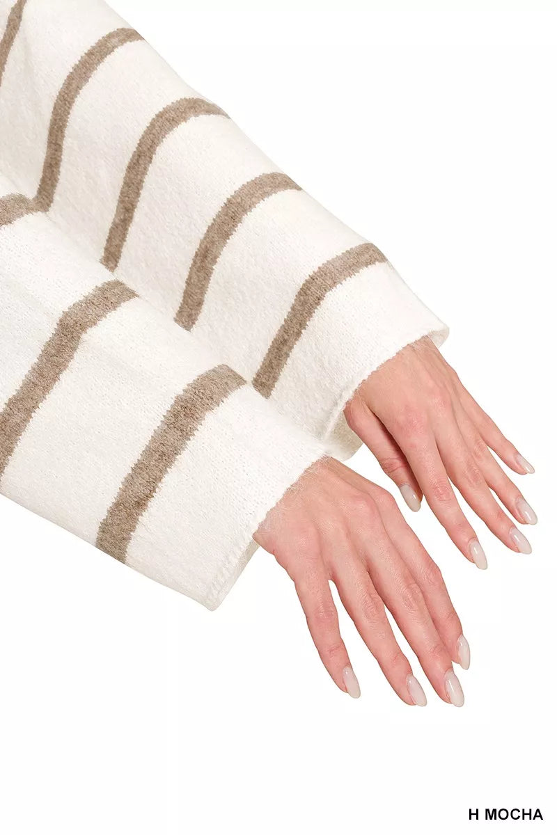 Close up of cream striped sweater sleeves with mocha stripes and wide cuffs.
