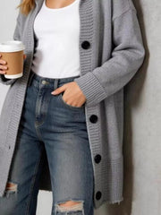 Close view of the gray hooded cardigan with black buttons and ribbed cuffs