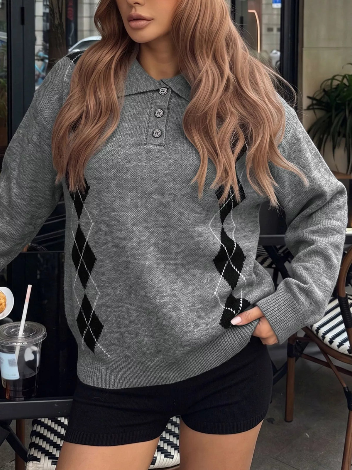 Front view of a gray polo collar sweater with black argyle panels down the sides