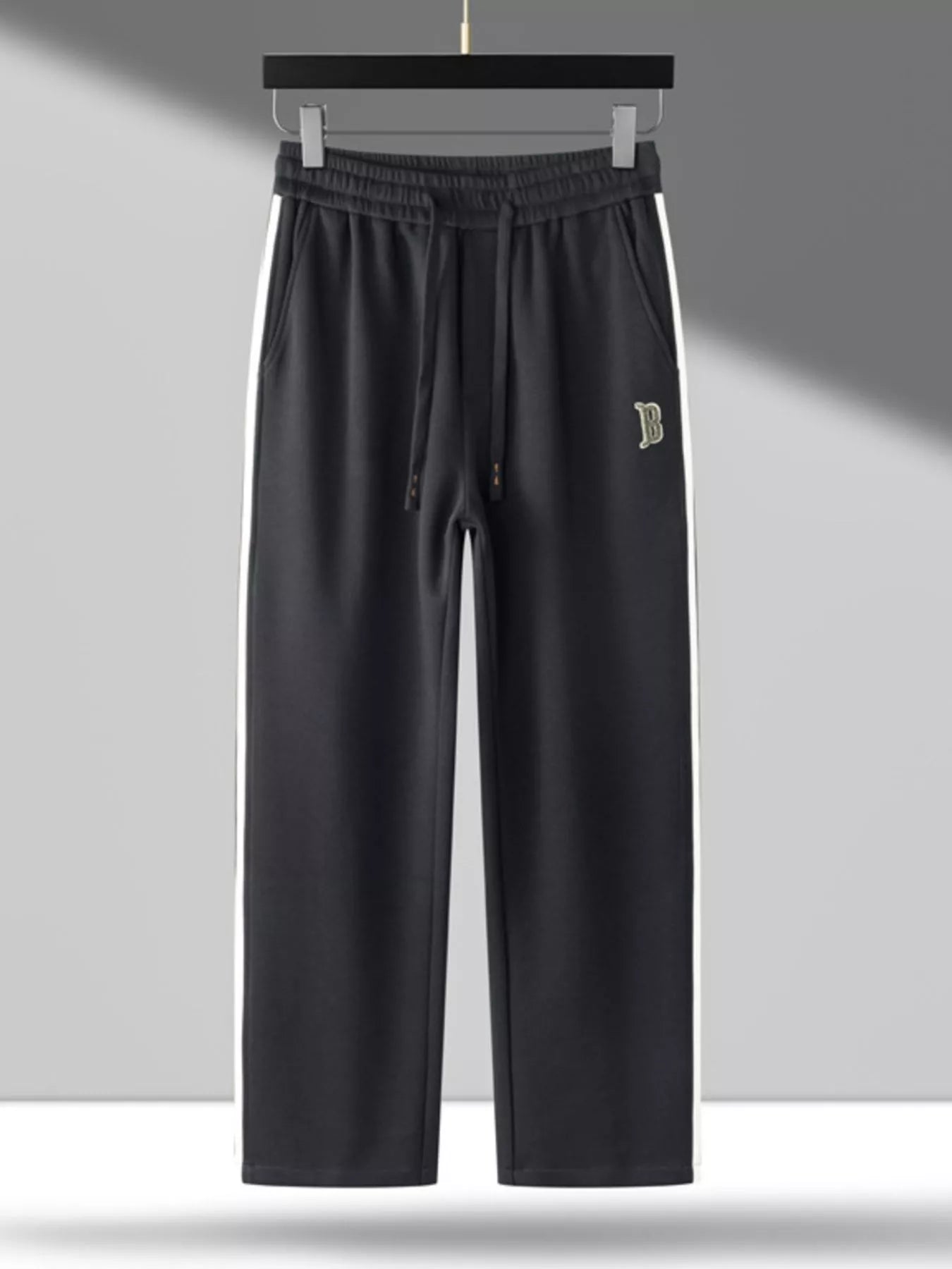 Men's side striped casual pants with a drawstring waist and pockets.