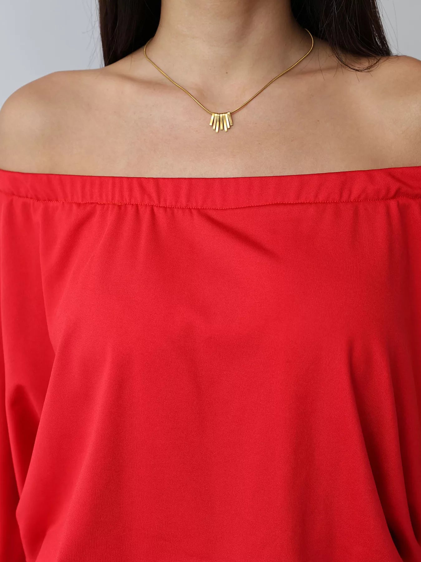 Red off shoulder mini dress neckline close up showing straight neckline and shoulder line