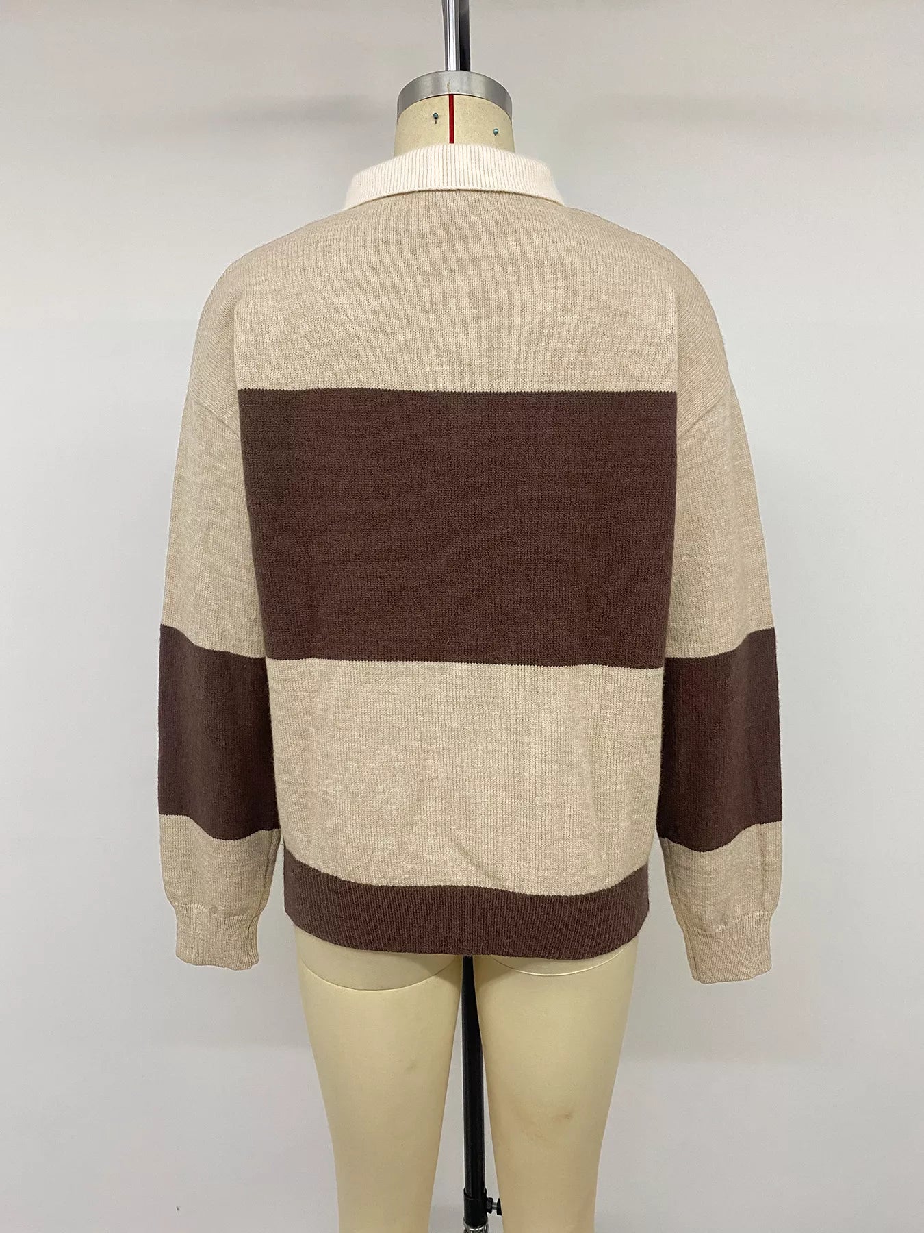 Back view of beige and brown color block polo sweater on a mannequin.