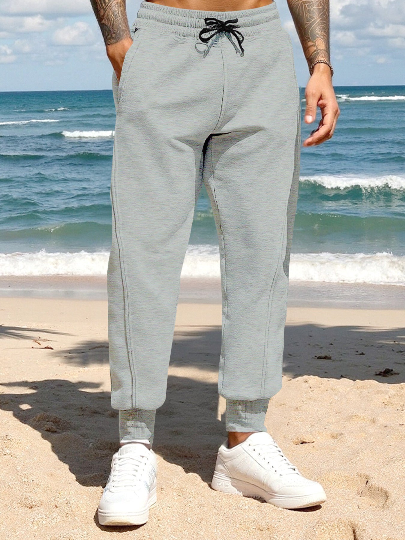 Men's light gray casual joggers with a drawstring waist and pockets.