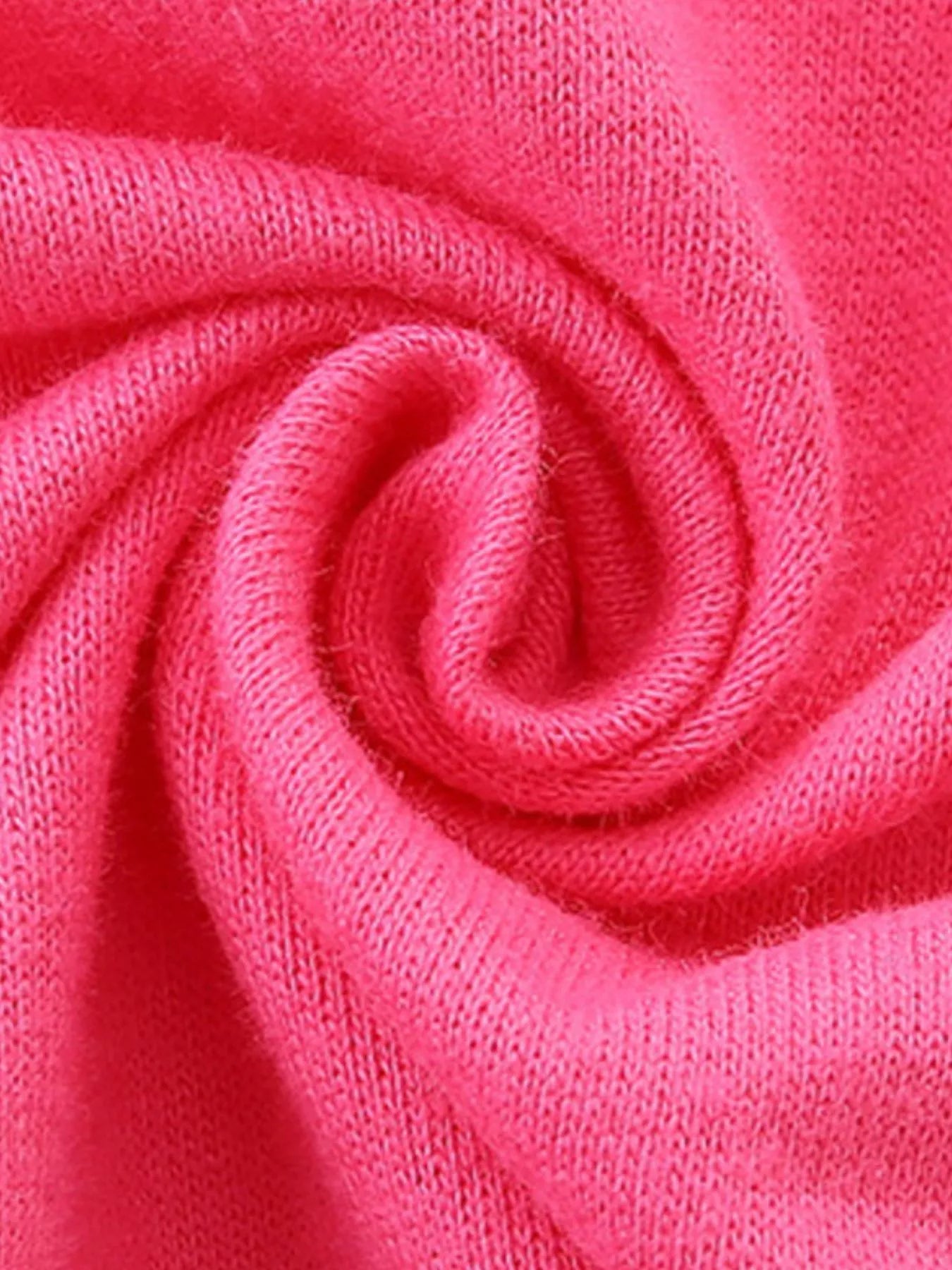 Close-up of the swirled strawberry pink fabric of the children's sweatshirt
