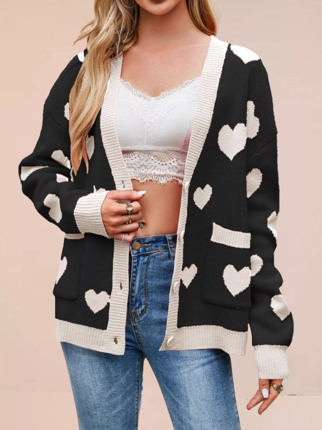 Black knit cardigan with white hearts and cream trim worn open