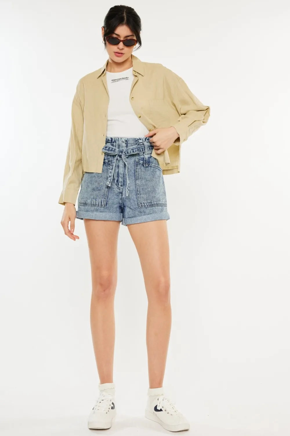 Women's ultra-high-rise denim shorts with a paperbag waist and pockets.