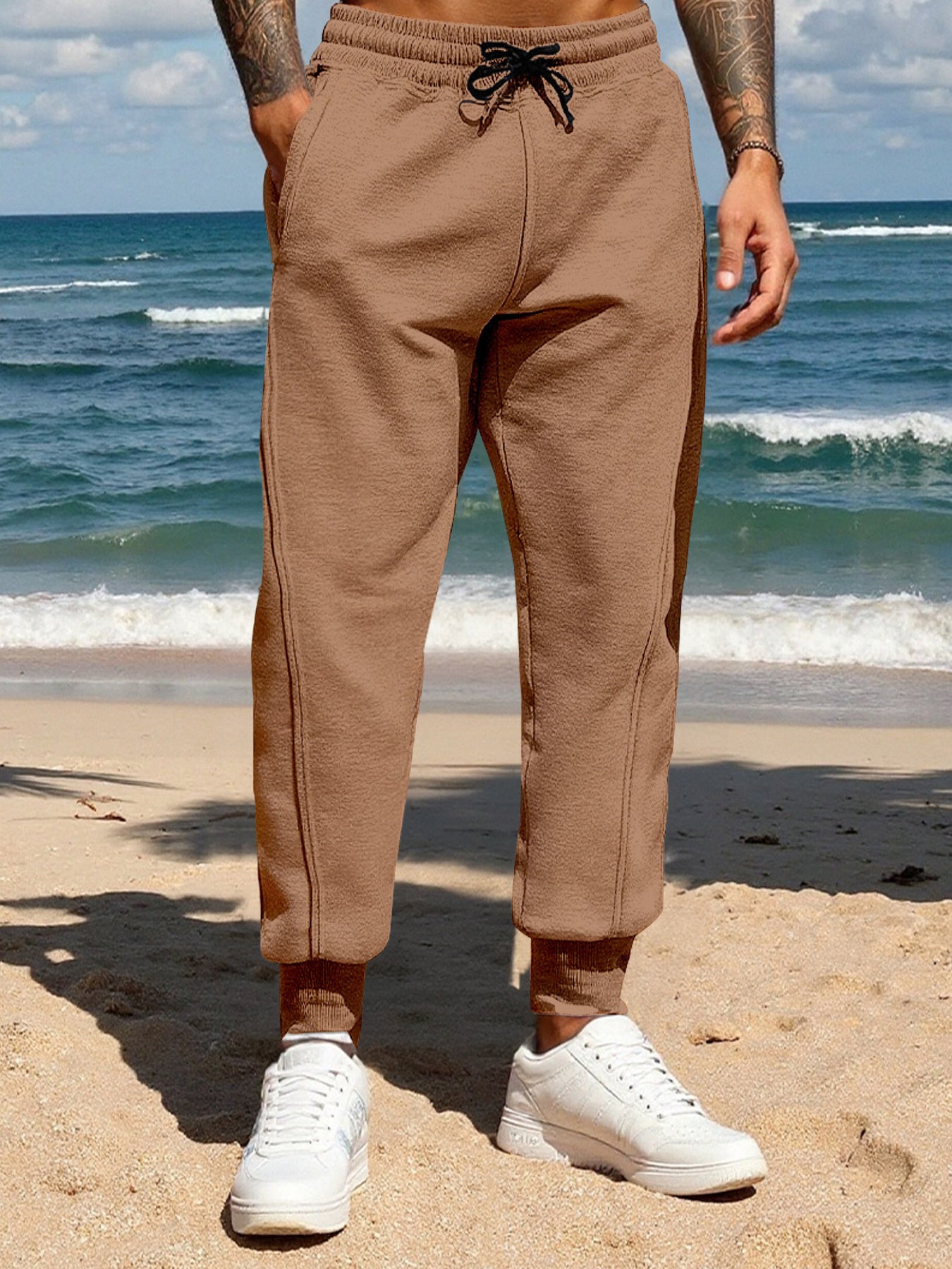 Men's brown casual joggers with a drawstring waist and pockets.