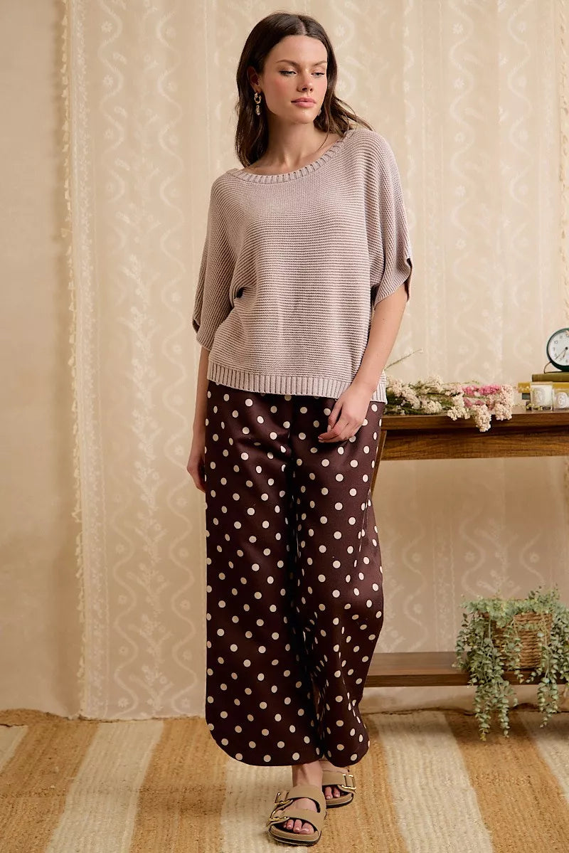 Full length front view of washed mocha dolman knit top with wide trousers.