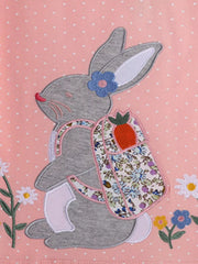 Close view of the grey rabbit applique with a floral backpack and embroidered flowers on pink fabric