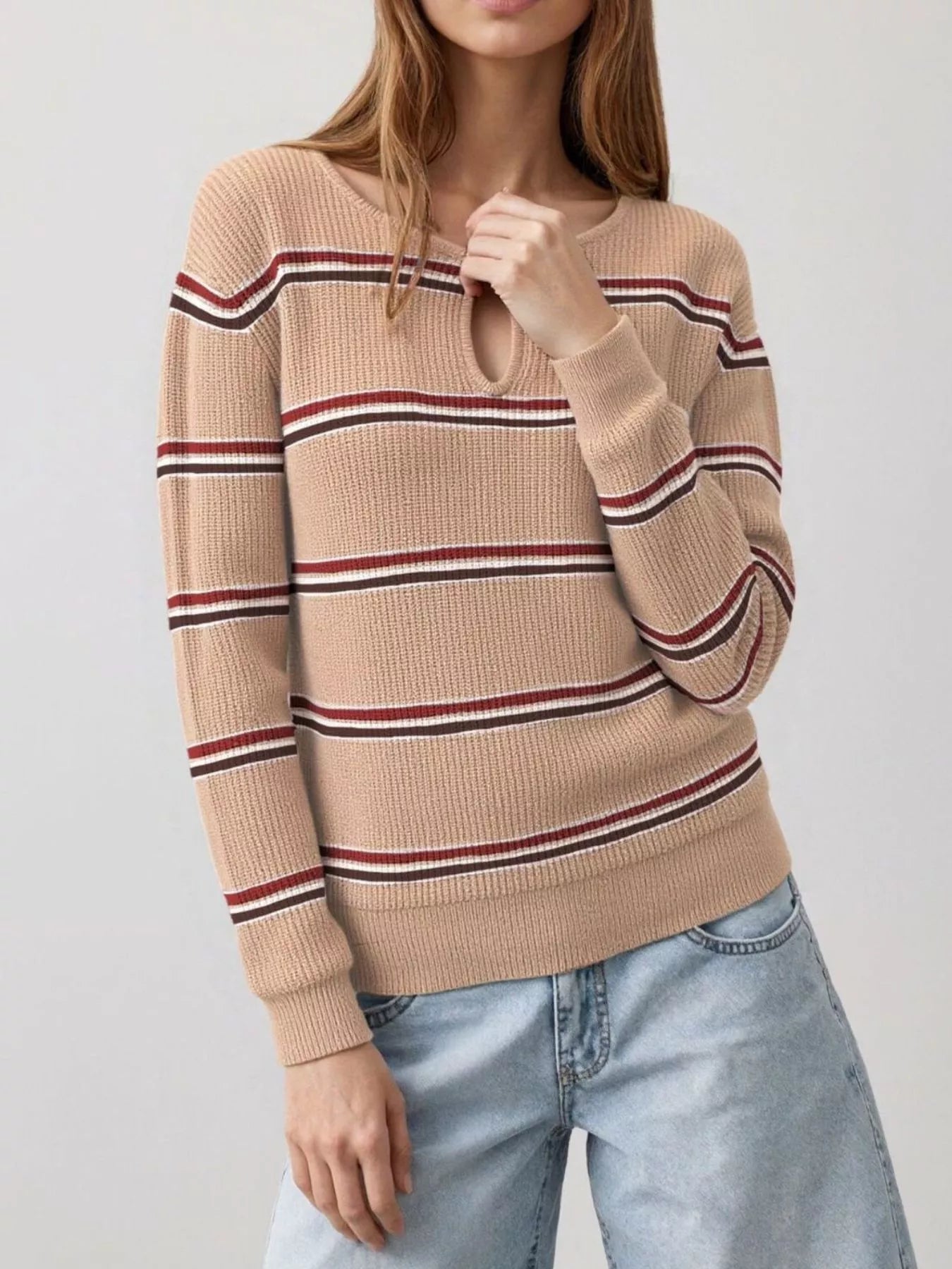 Front view of an apricot striped ribbed knit top with a keyhole neckline