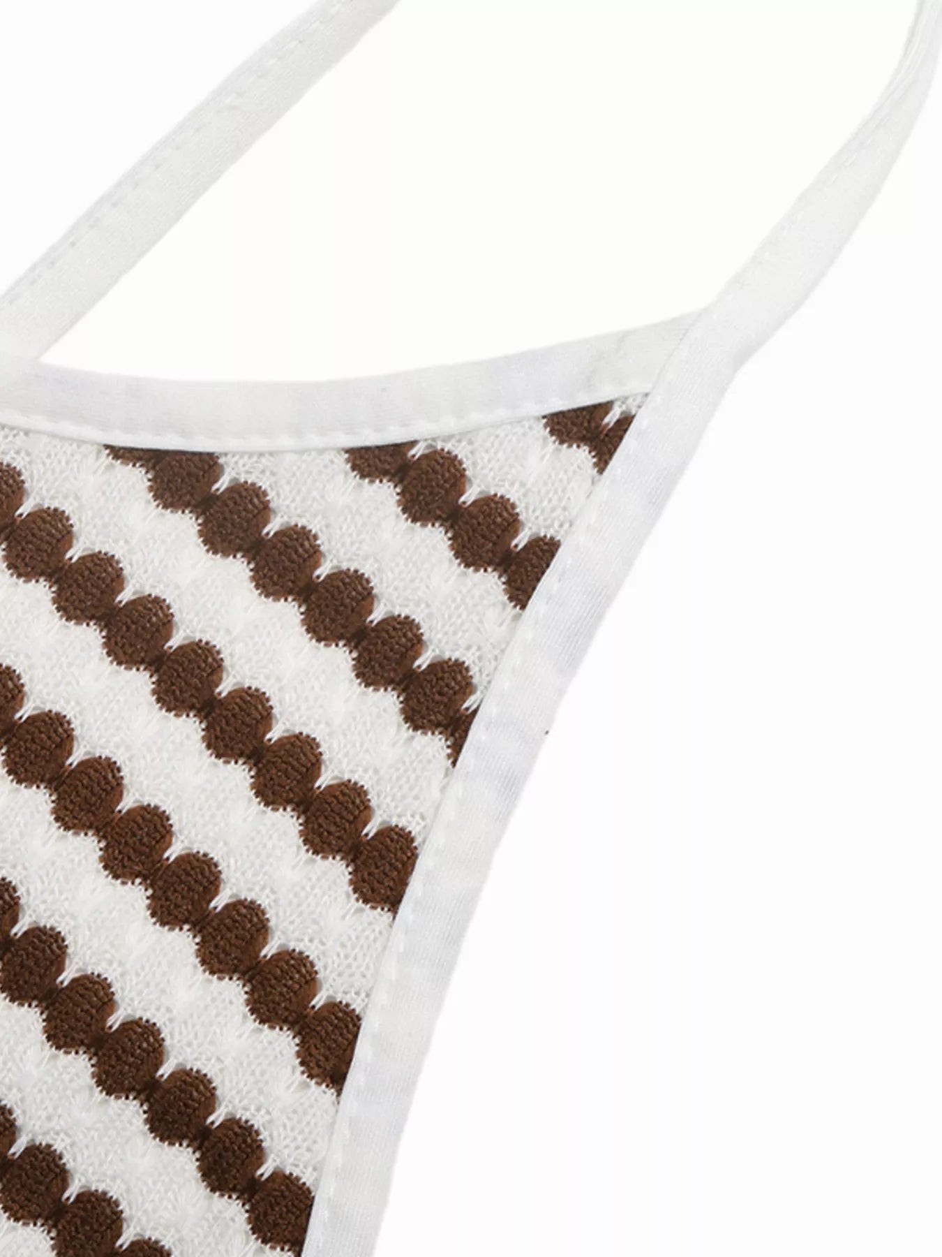 Close up of brown and white striped knit dress side strap and white trim detail