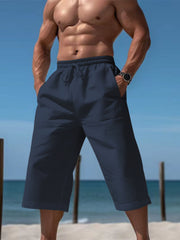 Men's navy cropped casual pants with a drawstring waist and pockets.