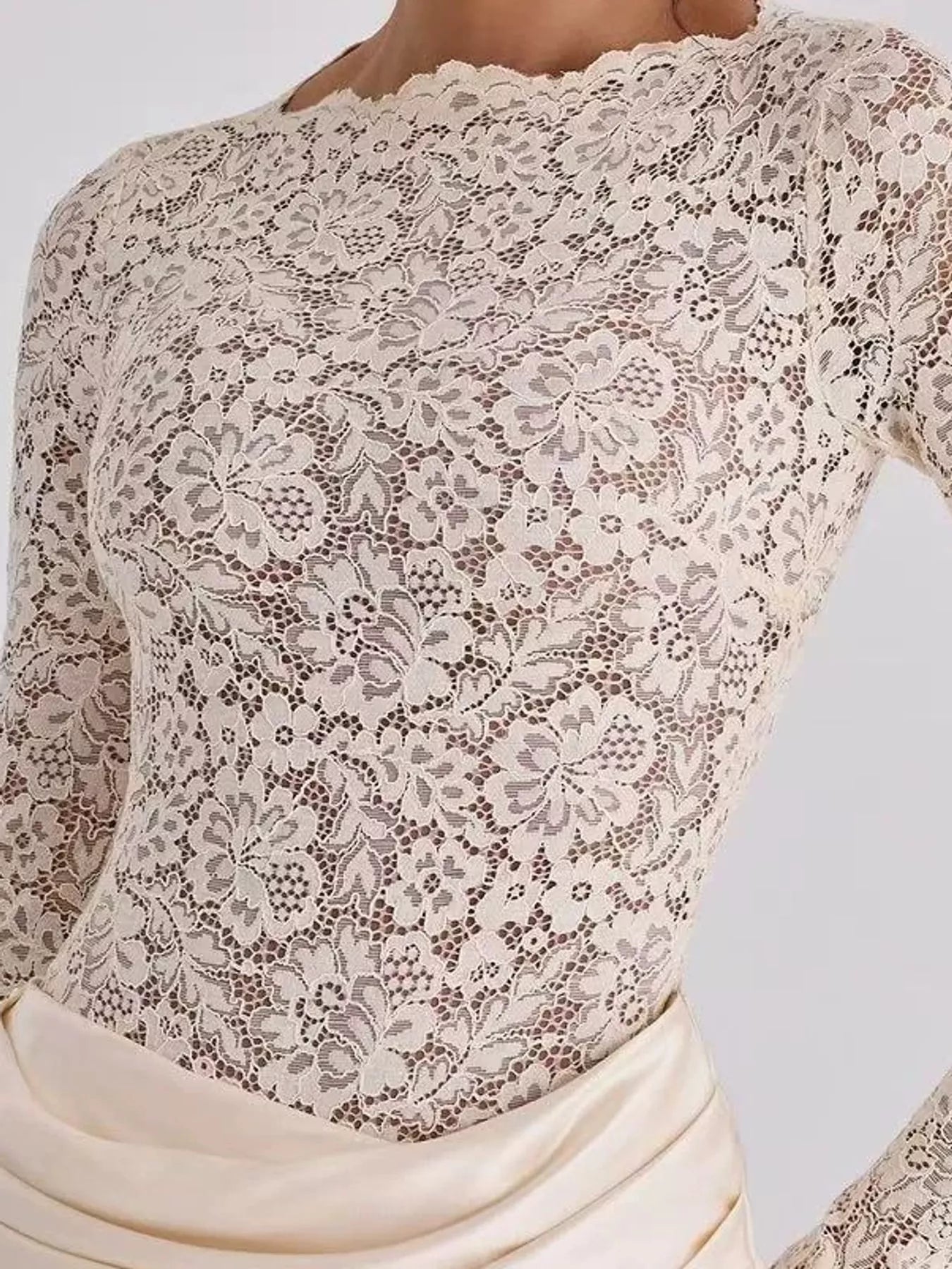 Close detail of ivory floral lace bodice and scalloped neckline on maxi dress