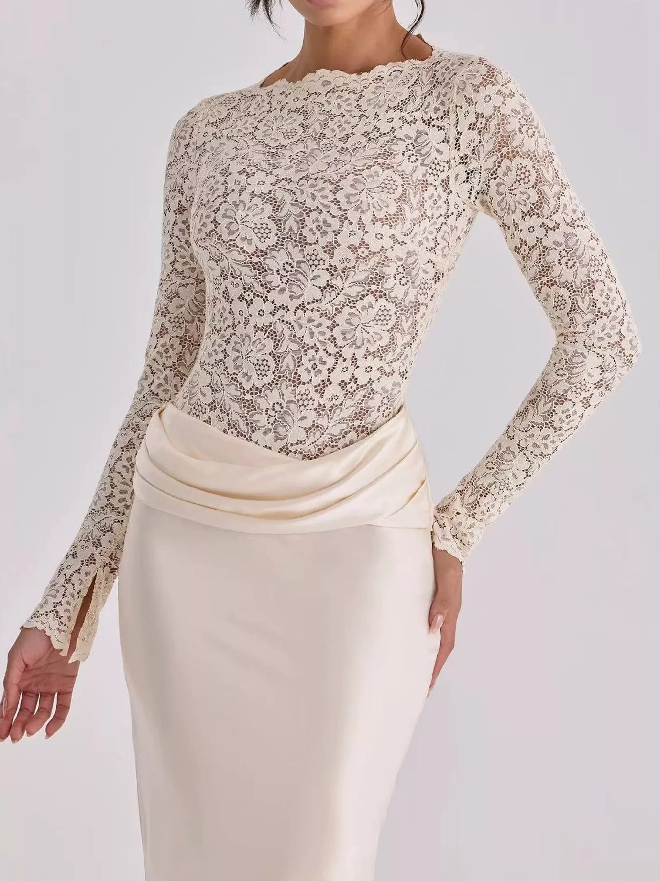 Close view of ivory floral lace bodice and draped satin waist on maxi dress
