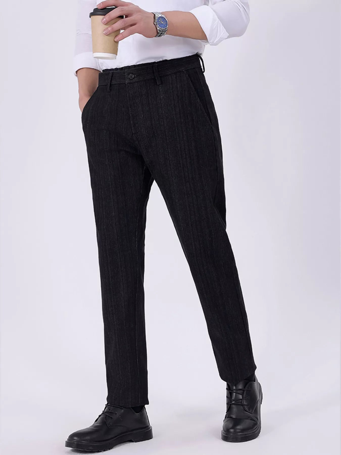 Men's black slim-fit pants with pockets and a cotton-blend composition.