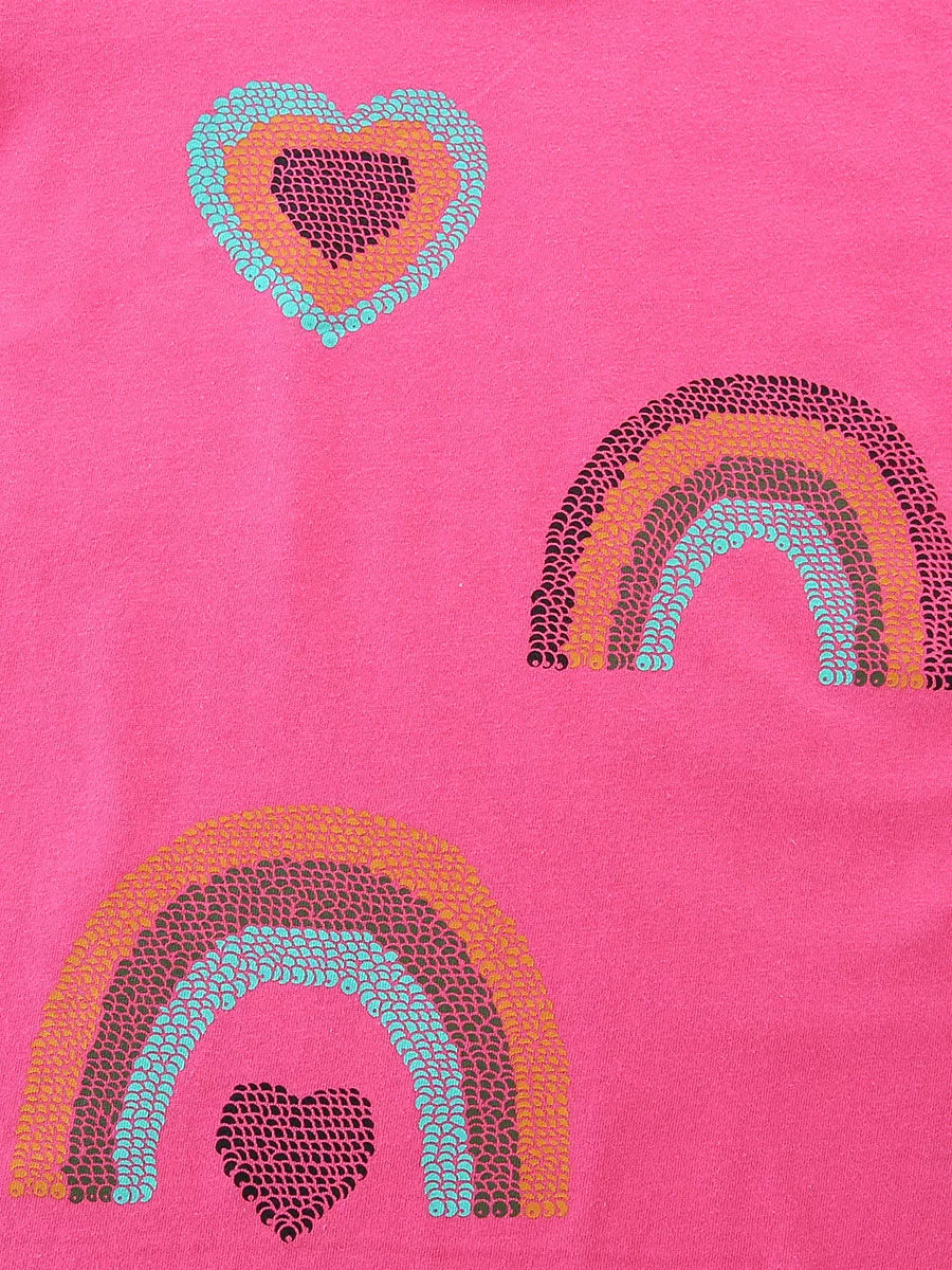 Close detail of sequin hearts and rainbows in turquoise orange and dark pink on pink tee