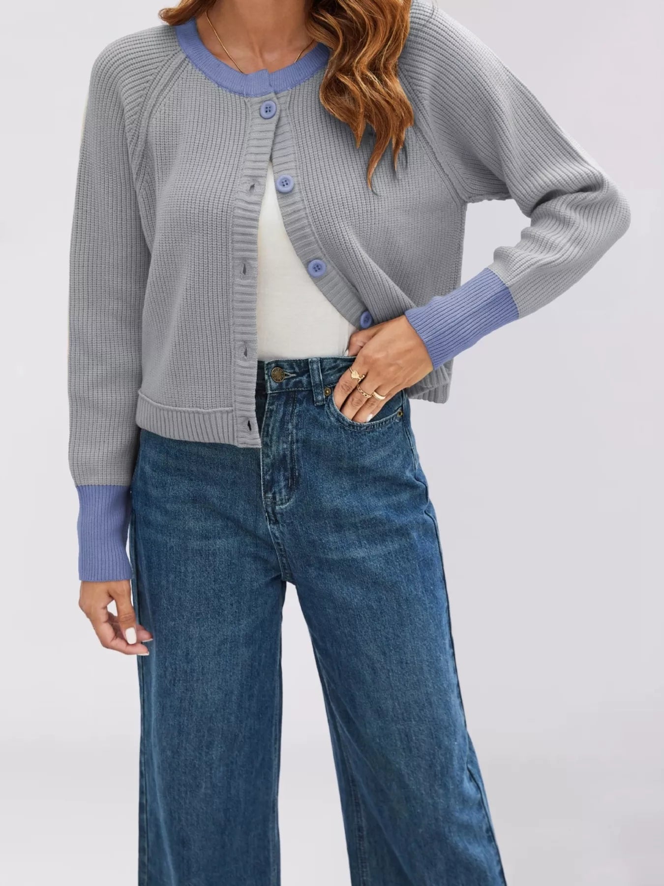 On-model front view of the gray cardigan with periwinkle trim and matching blue buttons