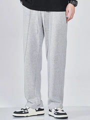Men's wide-leg sweatpants with a drawstring waist and pockets in the light gray color.