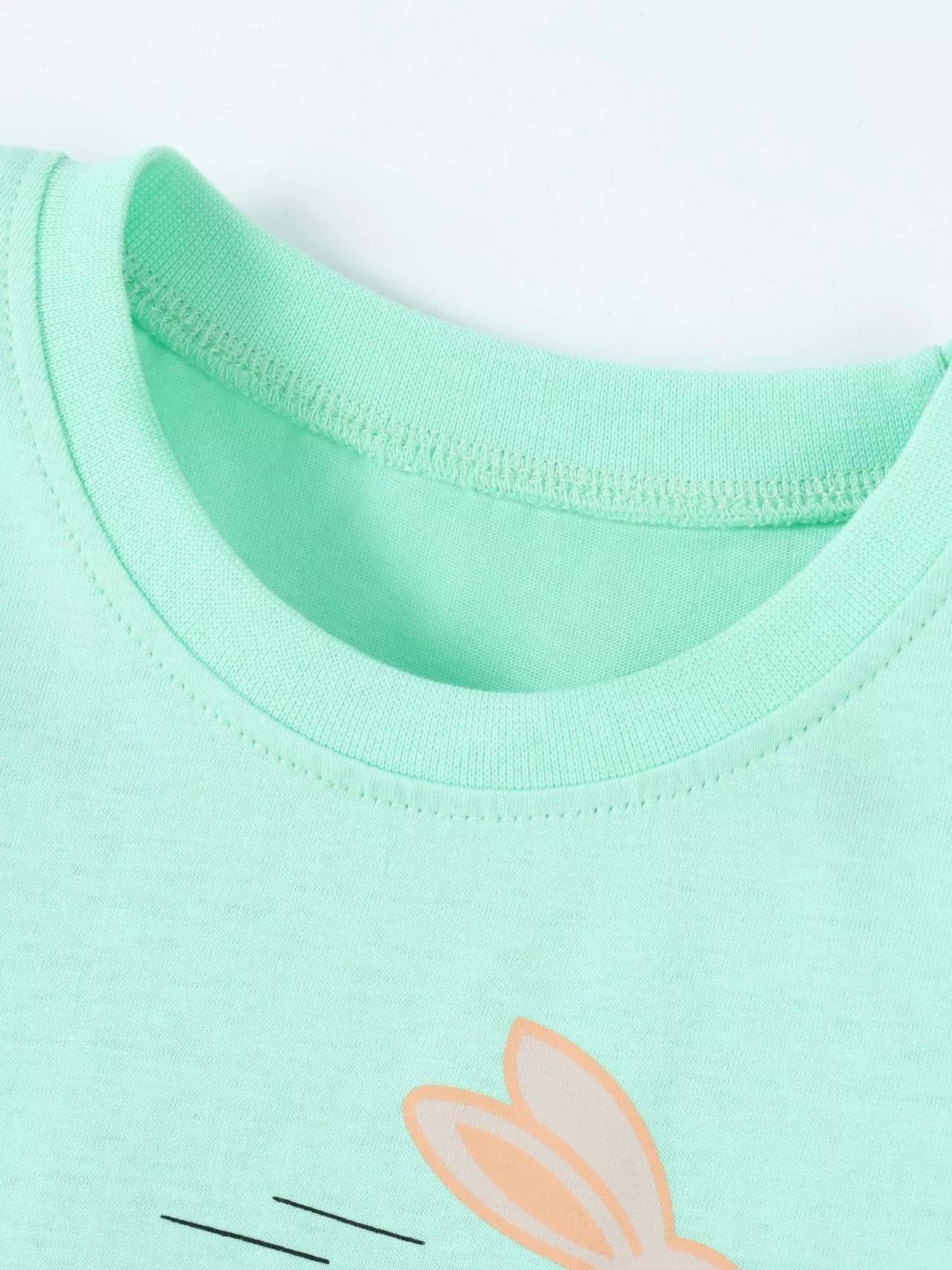 Close up of the green round neckline with the top of the bunny ears visible below