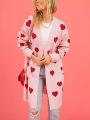 Front view of the pink heart print longline cardigan worn open over jeans