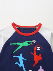 Close-up of the red round neckline and soccer player graphic on the dark navy tee
