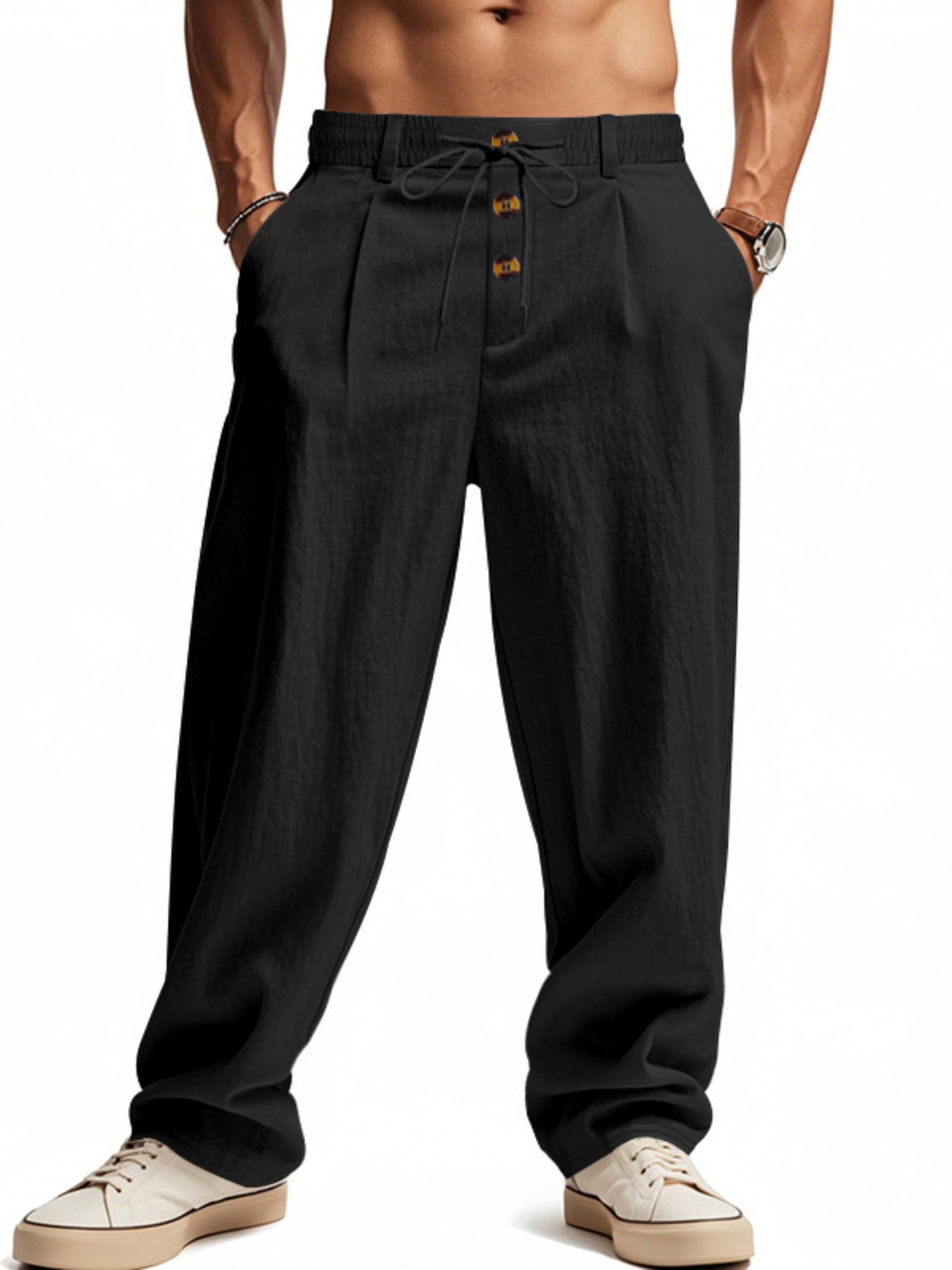 Men's black loose-fit pants with a drawstring waist and pockets.