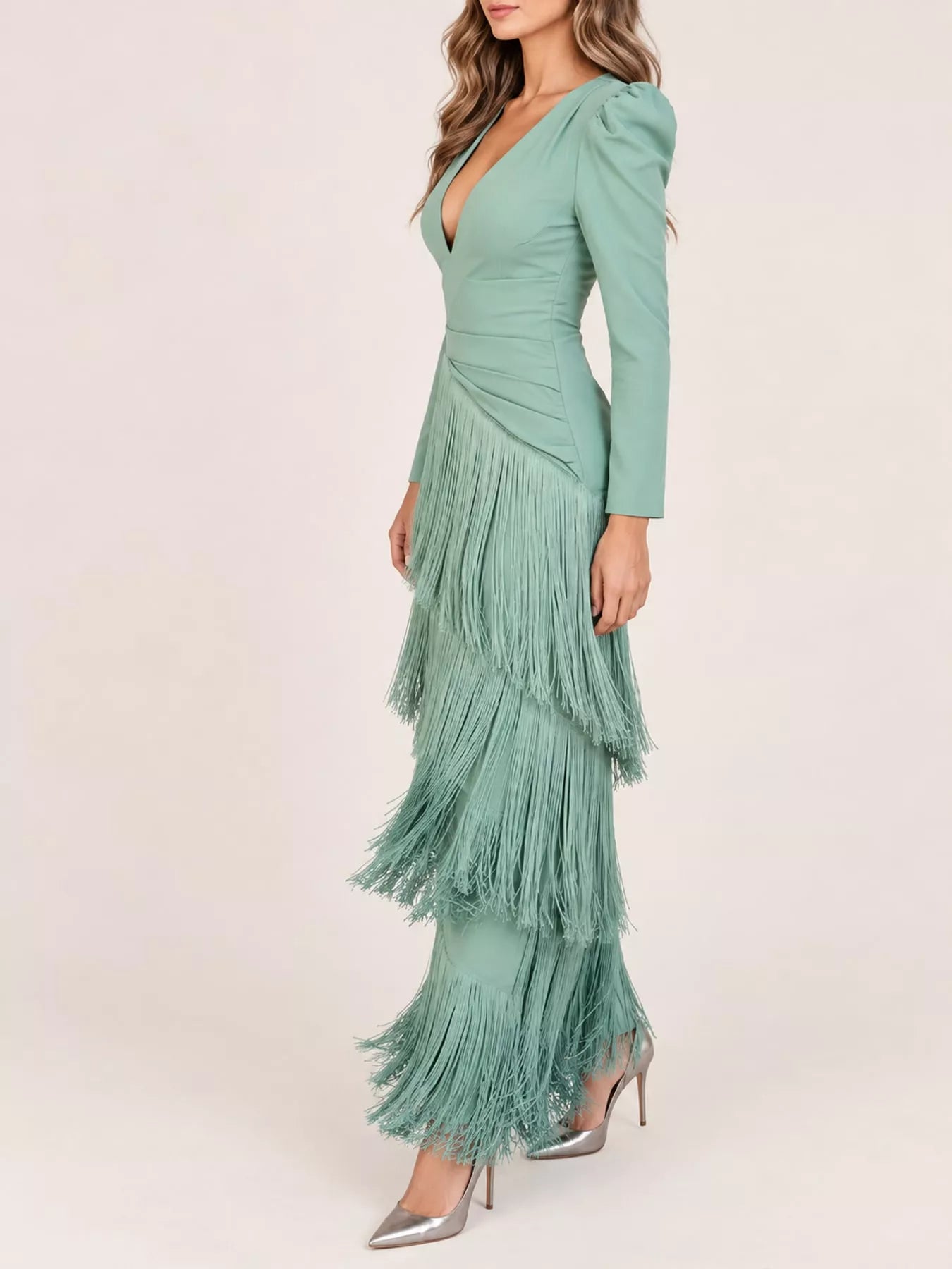 Side view of a gum leaf green fringed maxi dress in a studio showing the tiered fringe