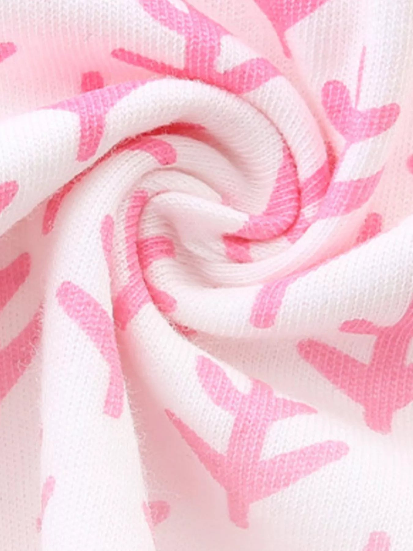 Close-up of the swirled blush pink patterned fabric of the children's seahorse tee