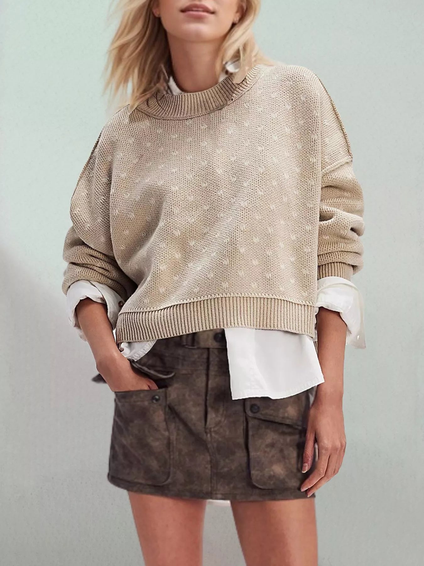 Khaki dotted knit sweater with ribbed crew neck and dropped shoulders worn layered over a white shirt