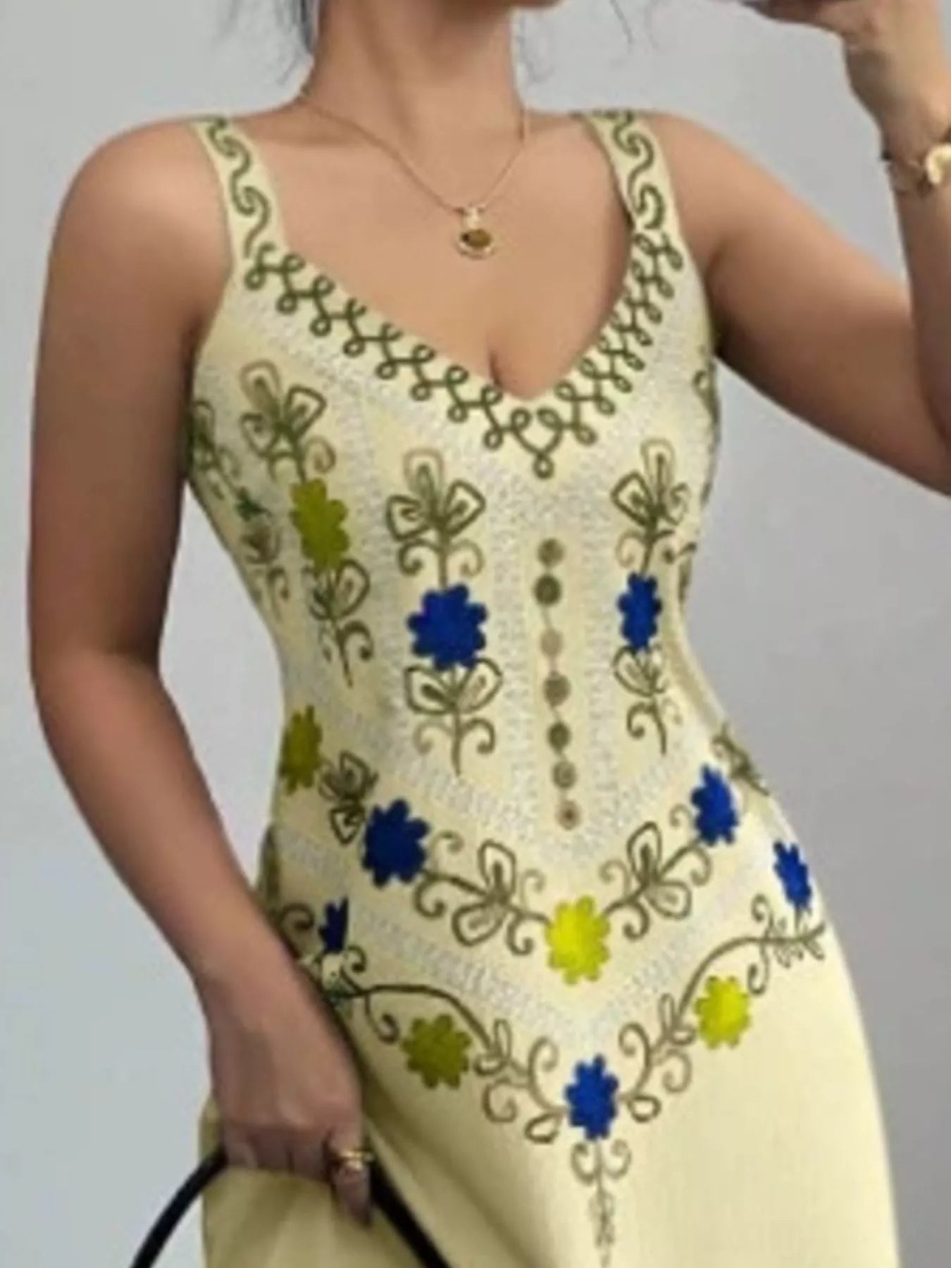 Close view of pastel yellow floral bodice with V neckline and patterned straps