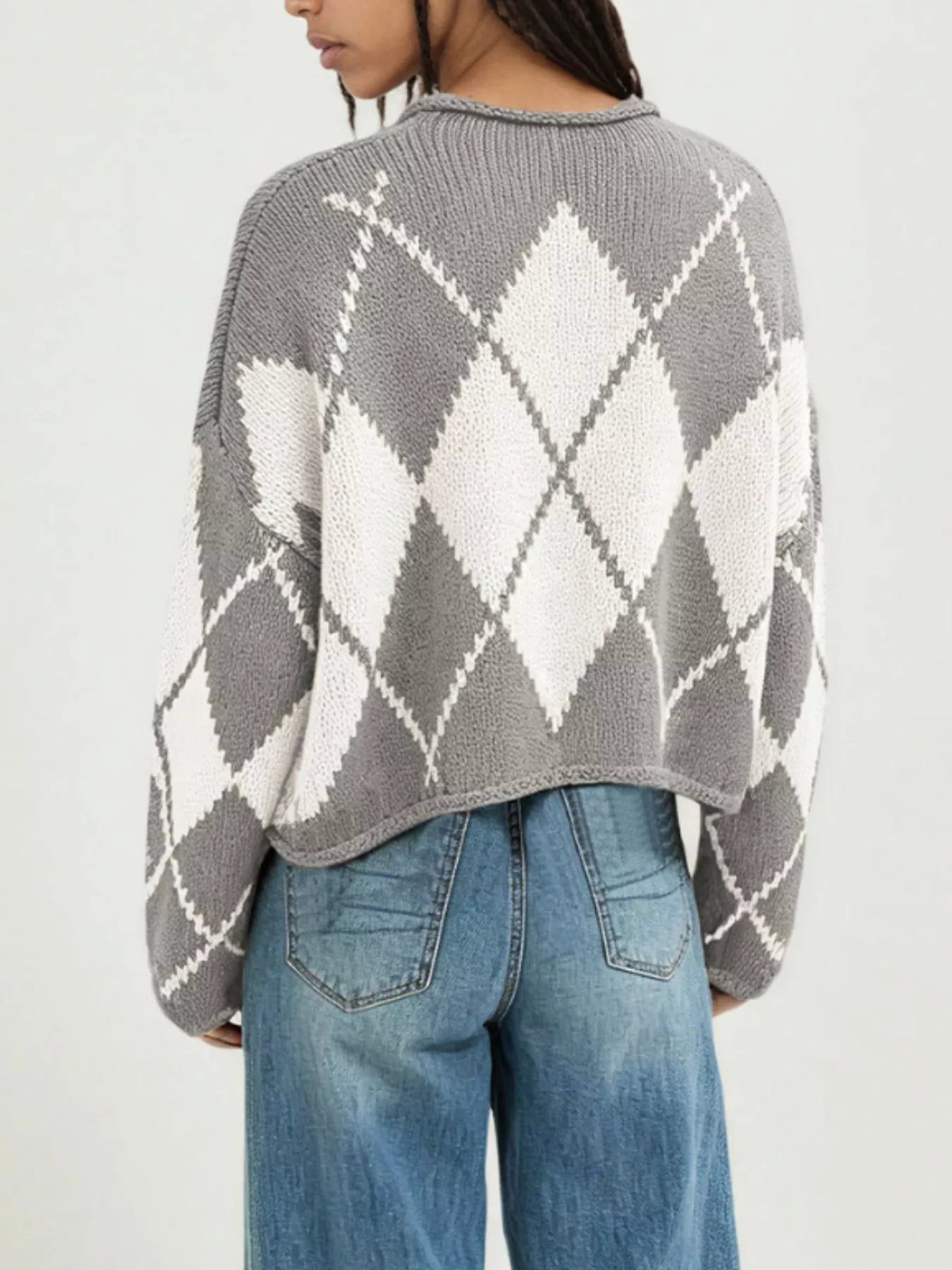 On-model back view of the gray and cream argyle knit sweater with dropped shoulders
