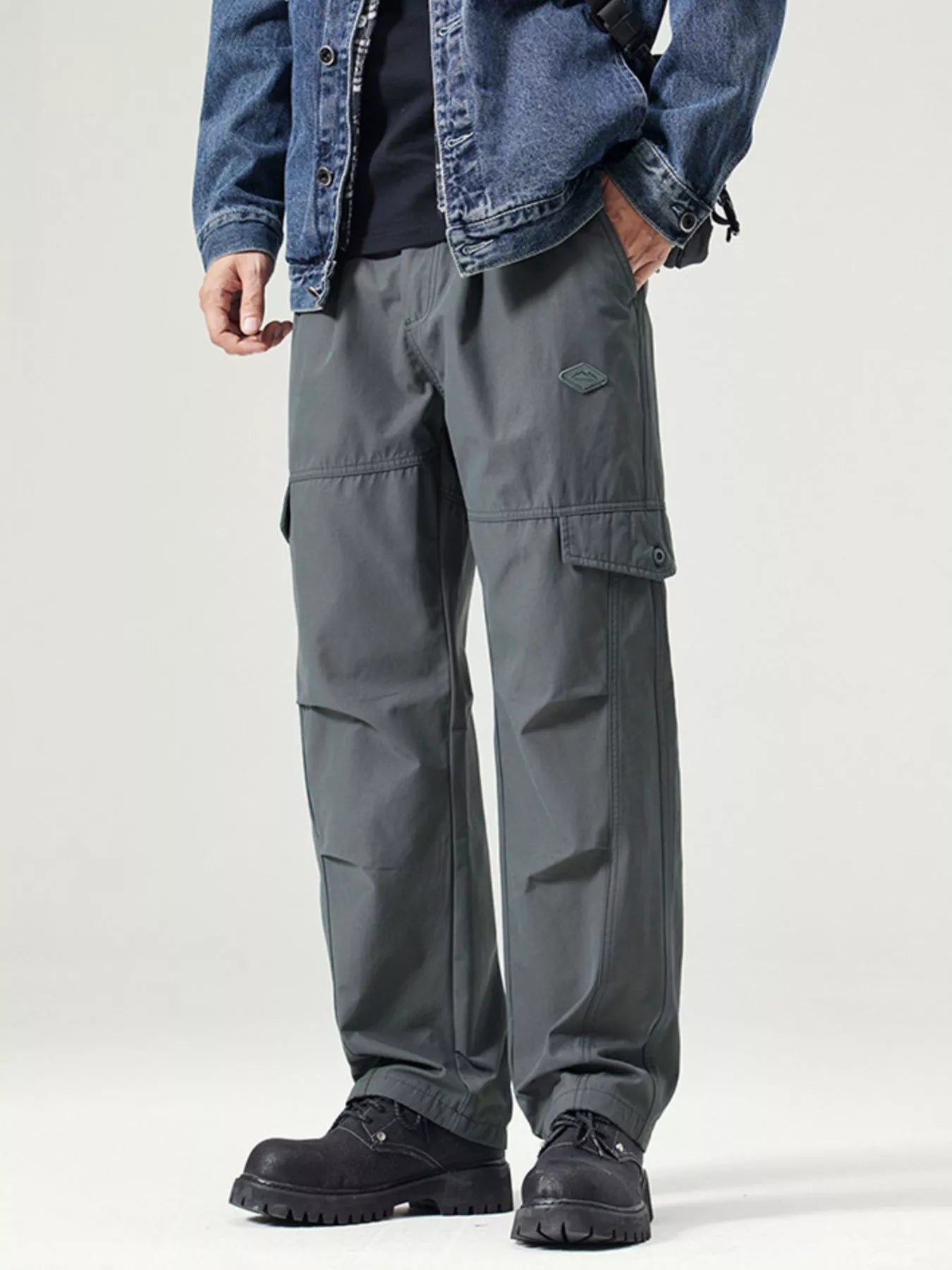 Men's dark gray wide-leg cargo pants with a drawstring waist and pockets.