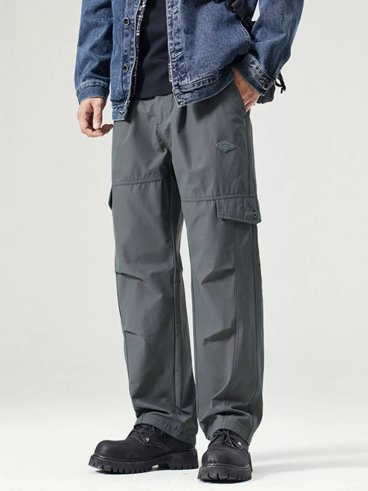 Men's dark gray wide-leg cargo pants with a drawstring waist and pockets.